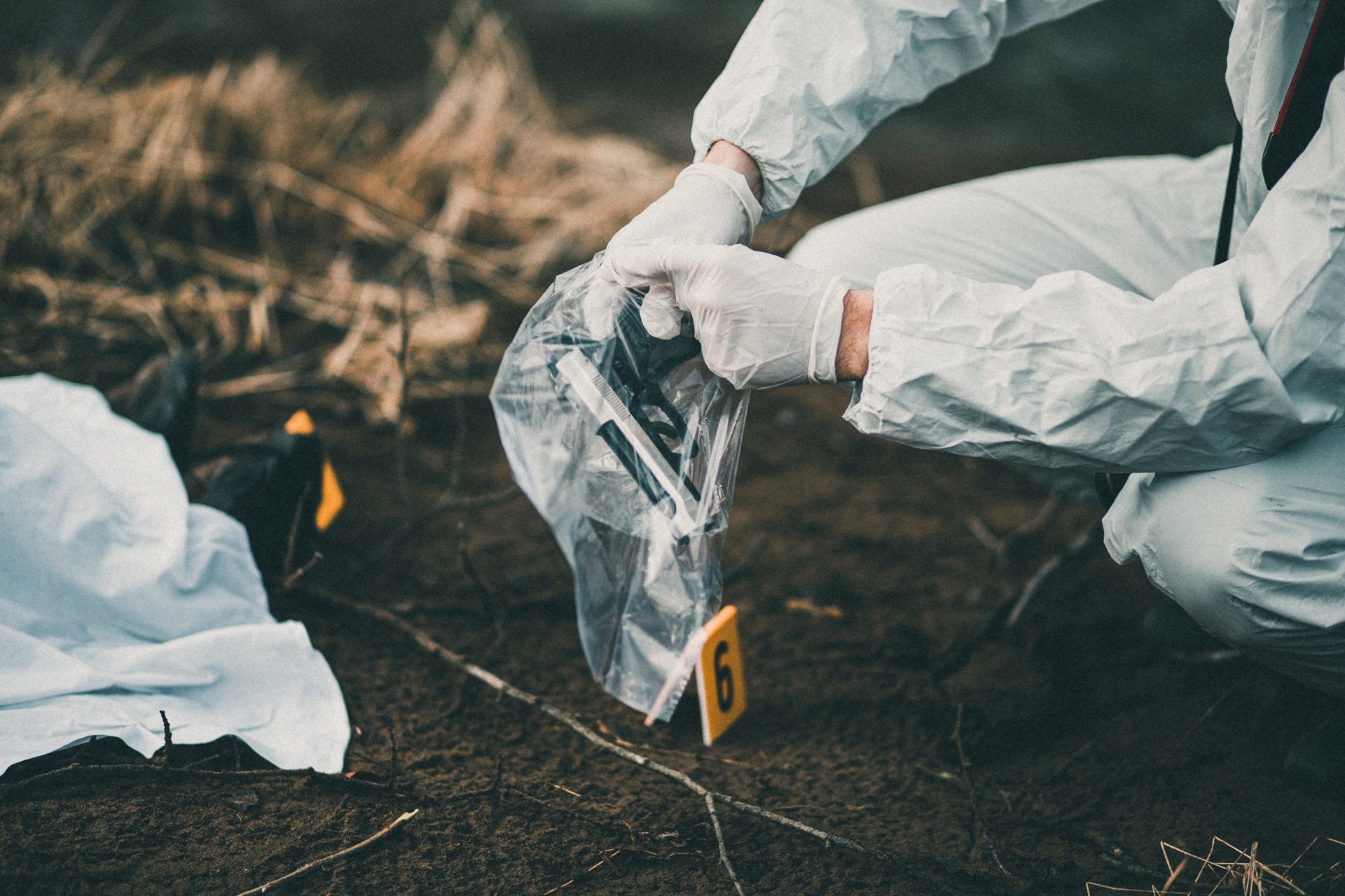 Crime scene pathologist with evidence from crime scene